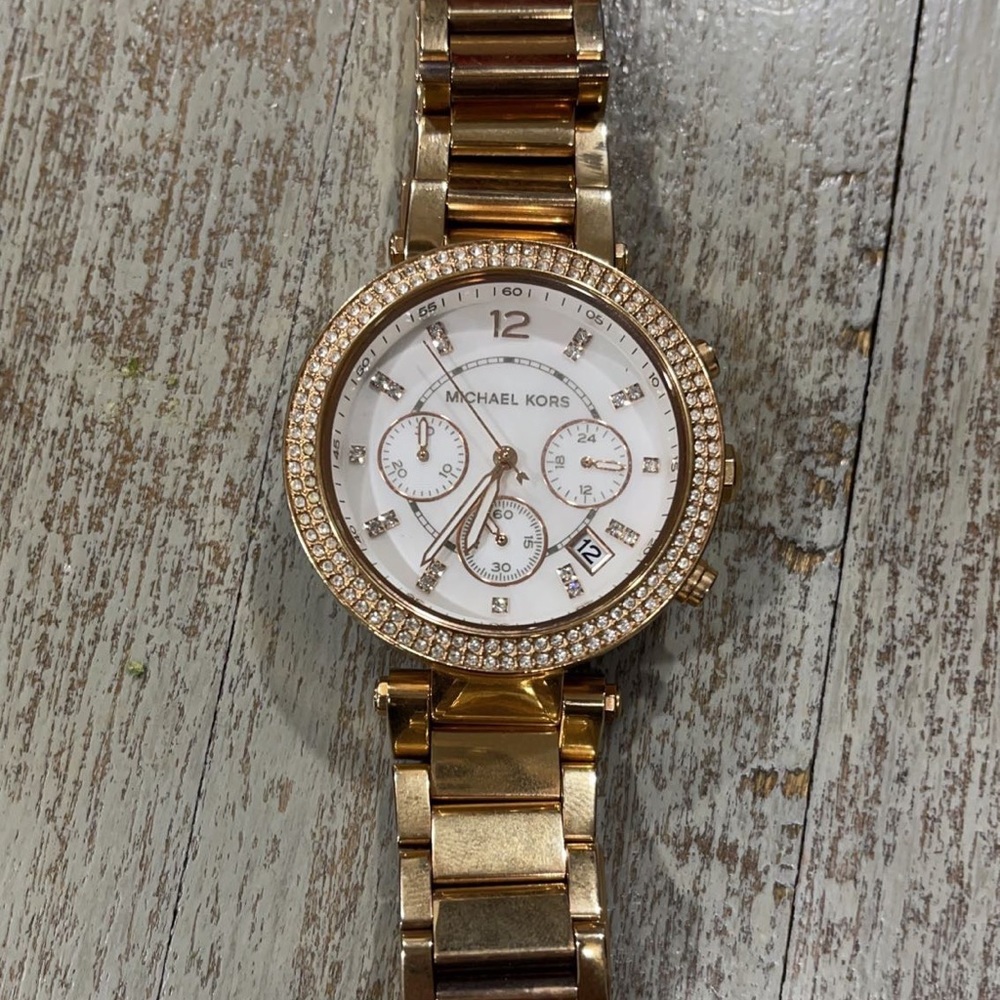 Beautiful Michael Kors rose gold watch with mother of pearl face.